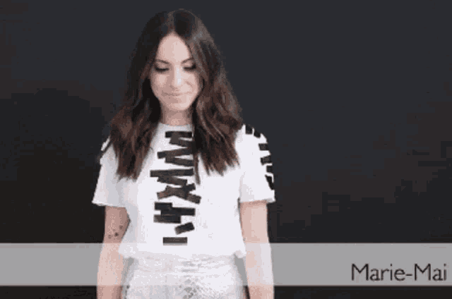 a woman is wearing a white shirt that says marie-mai on it