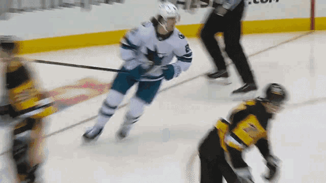 a hockey player with the number 8 on his jersey is skating on the ice