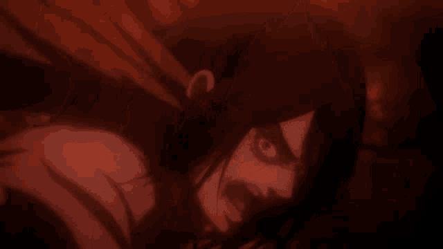 a close up of a person 's face with a red light behind it .