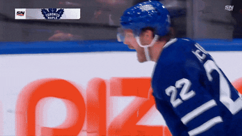 a hockey player in a blue jersey with the number 22 on the back