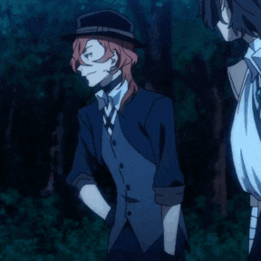 a man in a suit with his hands on his hips stands next to another man