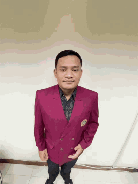 a man in a purple jacket has a badge on his chest that says ' a '