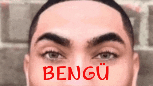 a close up of a man 's face with the word bengu in red letters