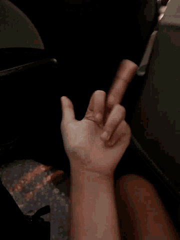 a close up of a person 's hand with their thumb pointing up