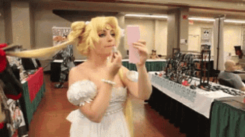 a woman taking a picture of herself in a mirror
