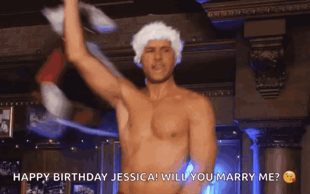 a shirtless man in a santa hat says happy birthday jessica and will you marry me