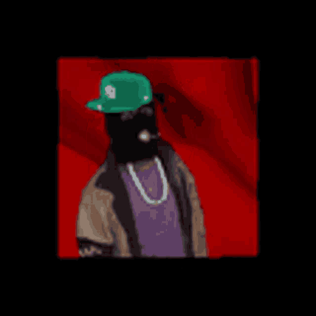 a man wearing a mask and a green hat with the letter s on it