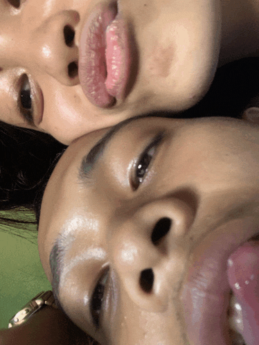 a close up of a person 's face with their tongue out
