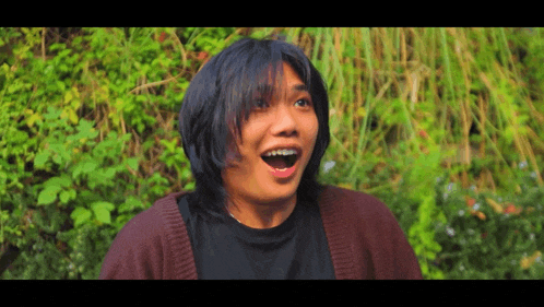 a person with braces on their teeth looks surprised