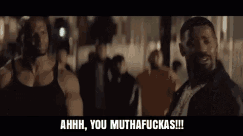 a man in a black tank top is laughing and says ahhh you muthafuckas