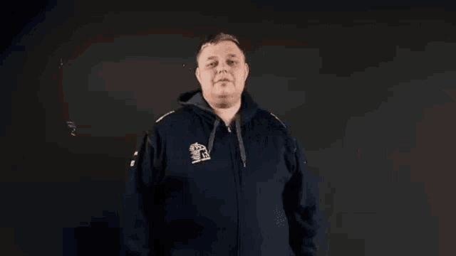 a man in a blue hoodie is making a funny face while making a funny face .