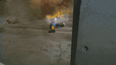 a silver car is parked in a parking garage next to a person