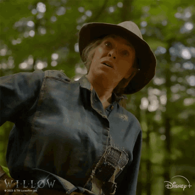 a woman in a cowboy hat says oh in front of a disney logo