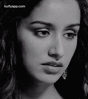 it is a black and white photo of a woman 's face .