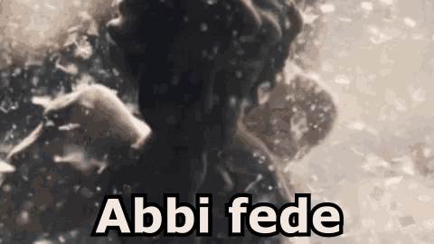 a person is swimming in the water with the words abbi fede written on the bottom .