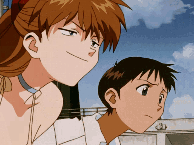 a boy and a girl are standing next to each other and looking at something