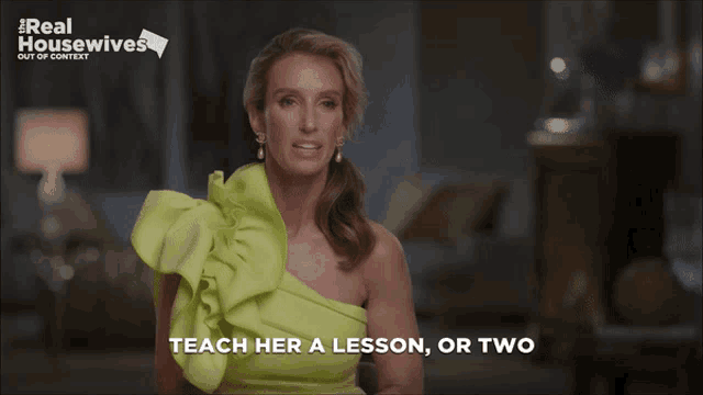 a woman in a green dress is talking about teaching a lesson