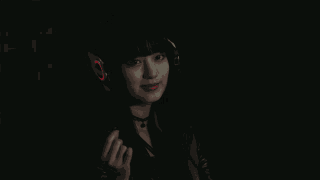a woman wearing headphones with a red circle on it
