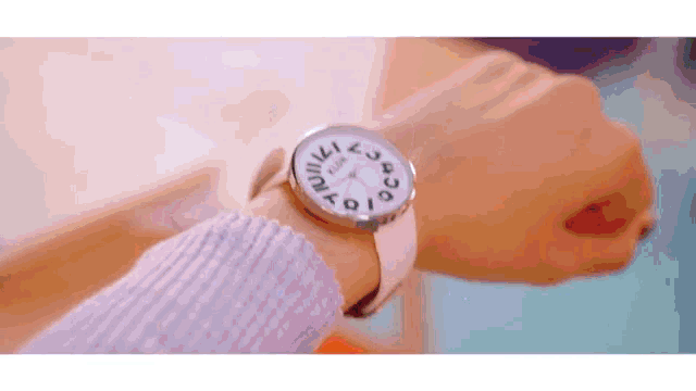 a close up of a person 's wrist wearing a watch that says ' lux ' on the face
