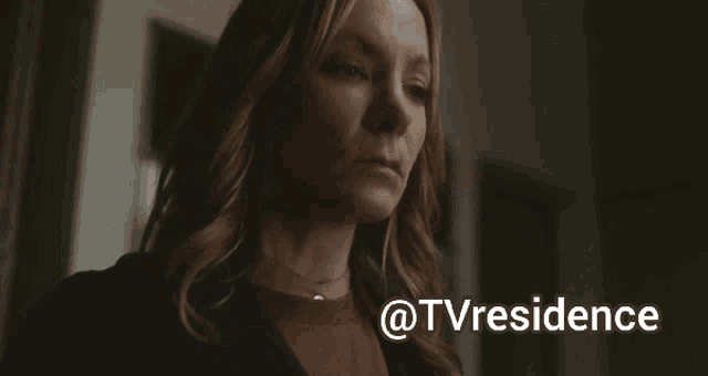 a woman drinking a glass of wine with the words @tvresidence behind her