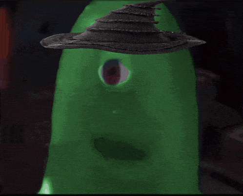 a green monster with a witch hat on