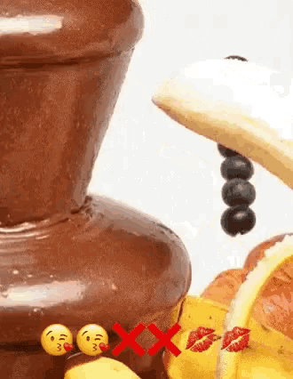 a close up of a chocolate fountain with smiley faces on the side