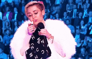 a woman in a white fur coat is holding a chanel purse