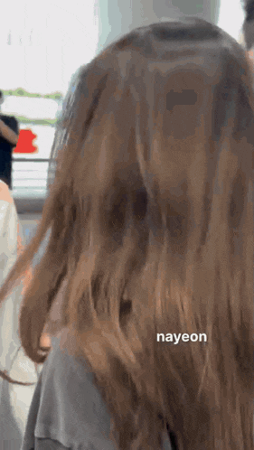 a close up of a woman 's hair with the name nayeon written on it .