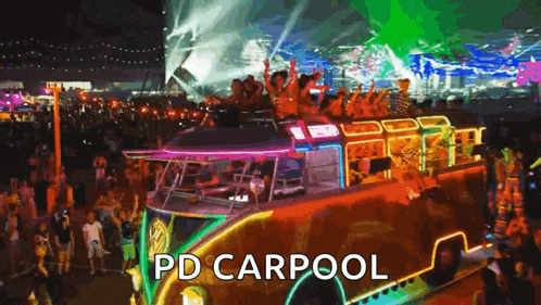 a group of people are riding on top of a bus at a festival .
