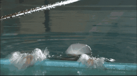 a woman in a blue bikini and goggles is swimming