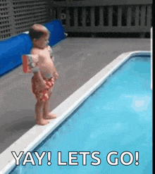 a baby is standing on the edge of a swimming pool with the words " yay lets go " above him .