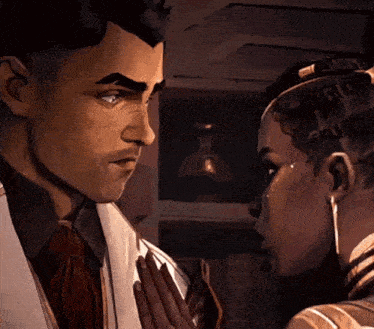 a man and a woman are touching each other 's faces in a dark room .
