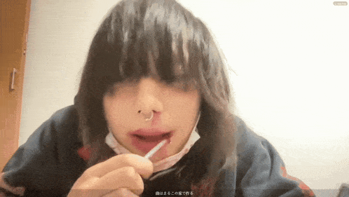 a person with a nose ring is eating something