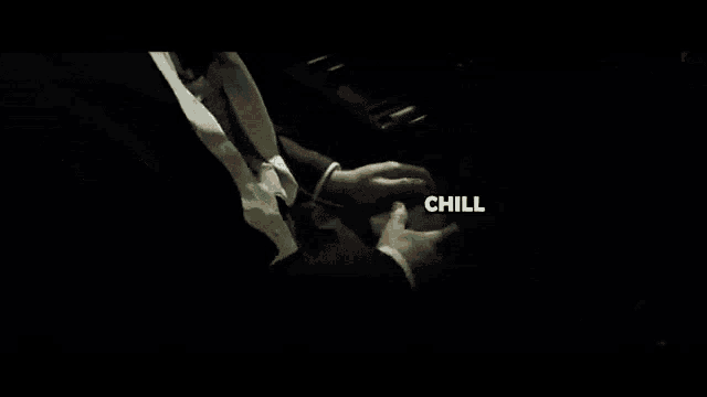 a man in a suit is playing a video game and the word chill is visible