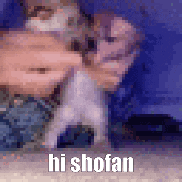 a blurry picture of a person holding a dog with the words hi shofan written below it