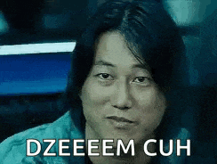 a close up of a man 's face with the words `` dzeeeem cuh '' written on the bottom .