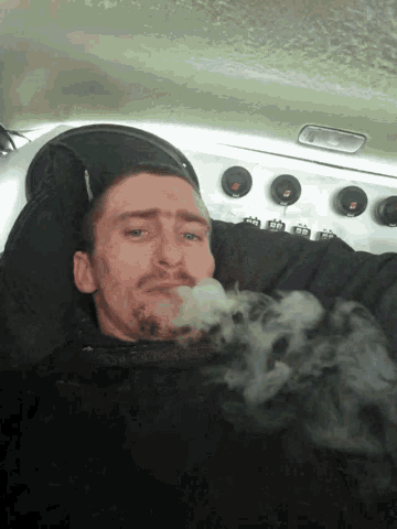 a man with smoke coming out of his mouth is wearing a black shirt that says abercrombie