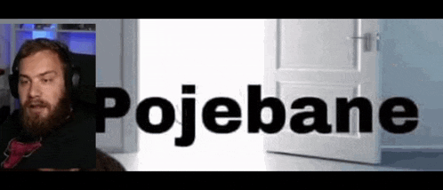 a man with a beard is sitting in front of a door and the word pojebane is written on it .