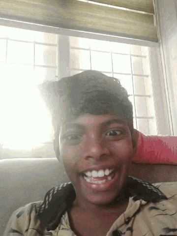 a young boy with a broken arm smiles for the camera