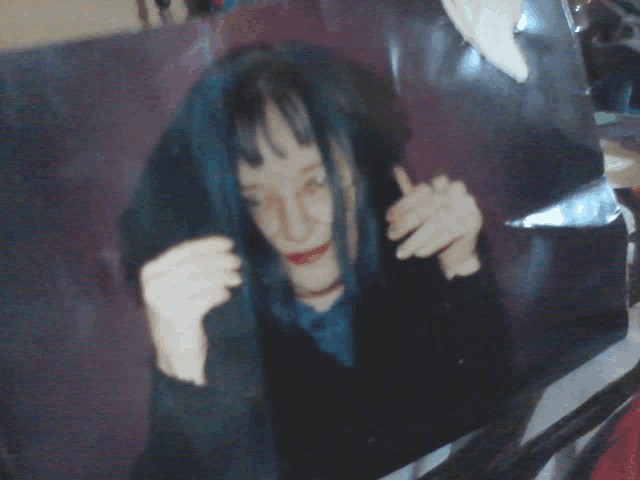 a picture of a woman with long blue hair