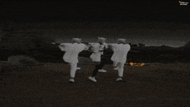 a blurred image of a group of people with the letter t on the bottom right
