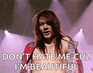 a man in a plaid shirt is saying " don t hate me cuz i 'm beautiful " .