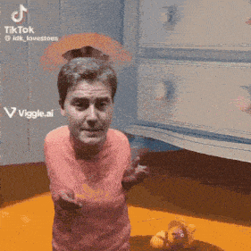 a man in a pink shirt is standing in front of a dresser with a viggle.ai logo on it
