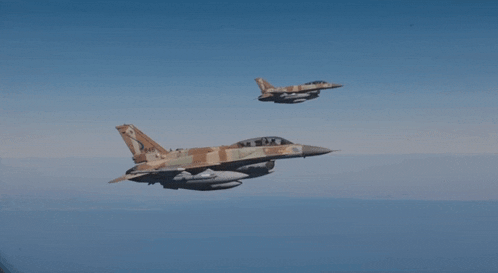 two fighter jets are flying in the sky and one of them has a marking on the tail that says ' a '