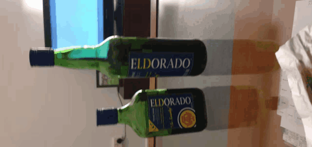 two bottles of eldorado sit on a table next to each other