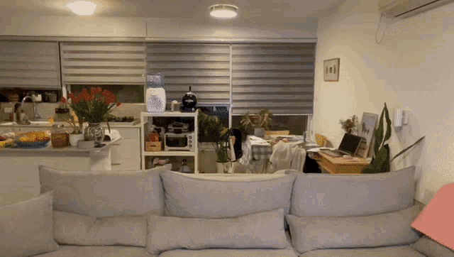 a living room with a couch and a shelf with a sign that says ' i love you ' on it