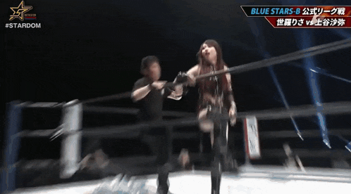 a woman is standing in a wrestling ring with a stardom logo on the bottom
