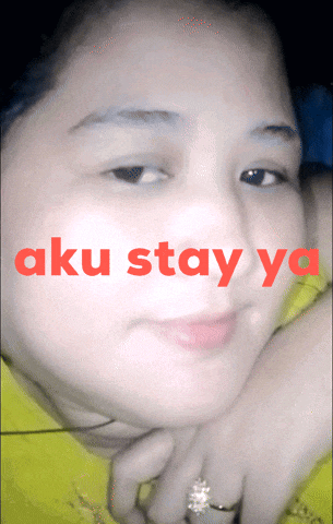 a close up of a woman 's face with the words aku stay ya written in red