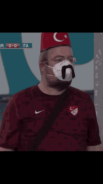 a man wearing a mask and a hat with a crescent moon on it