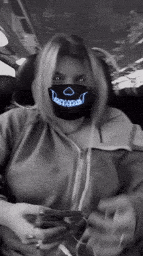 a woman wearing a mask with a smiley face